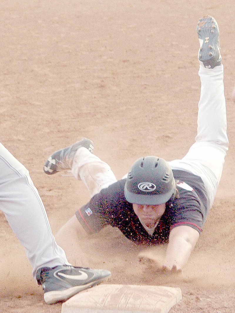 Photo by Rick Peck McDonald County&#8217;s Tray Black dives safely into third base before scoring the winning run on Kameron&#8217;s Hopkins hit in McDonald County&#8217;s 6-5 win over Cassville.