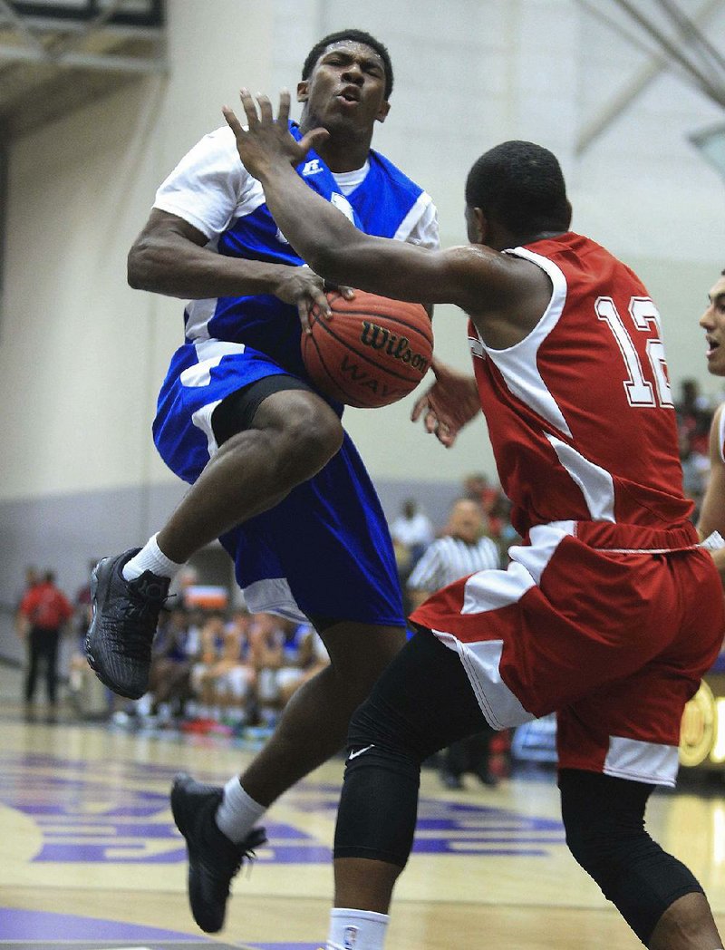 Kelvin Robinson (left) of the East puts up a shot against Chave Zackary of the West during the East’s 100-97 victory over the West on Thursday at the state high school All-Star boys basketball game in Conway. To see more photos from the All-Star games, visit arkansasonline.com/galleries. 