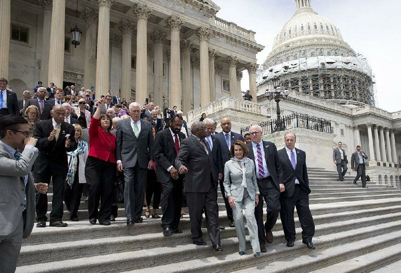 Democrats, led by House Minority Leader Nancy Pelosi, descend the steps of the U.S. Capitol to speak Thursday after ending their sit-in protest calling for a vote on gun-control measures.