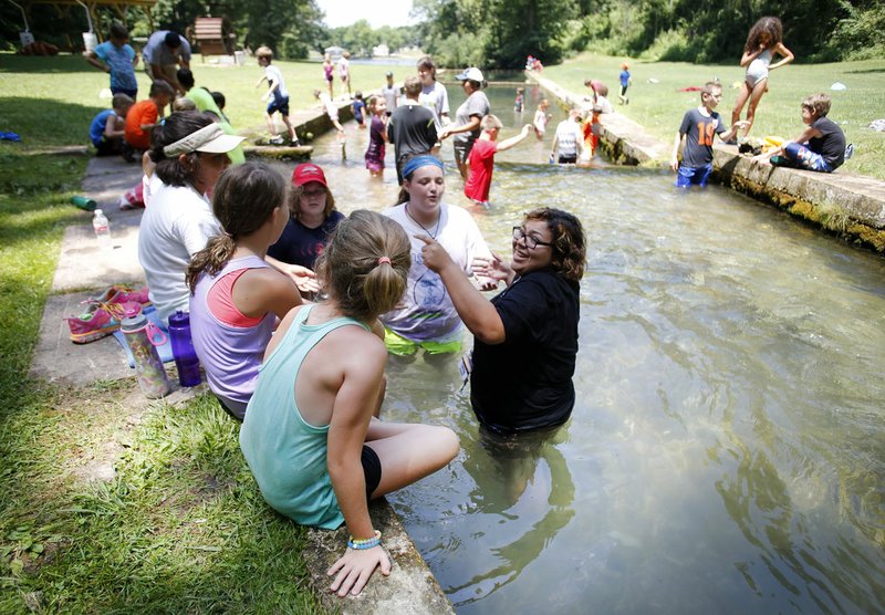 Merscedez Ruiz (right), an intern, speaks Thursday with other participants in the Art and Nature Camp at the Illinois River Watershed Partnership’s Watershed Sanctuary in Cave Springs. According to new data from U.S. Census Bureau, young demographic makes up a key part of Northwest Arkansas’ population.