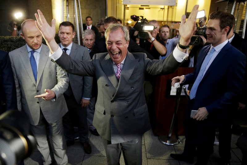 Nigel Farage, the leader of the UK Independence Party, celebrates and poses for photographers as he leaves a "Leave.EU" organization party for the British European Union membership referendum in London, Friday, June 24, 2016. On Thursday, Britain voted in a national referendum on whether to stay inside the EU. (AP Photo/Matt Dunham)

