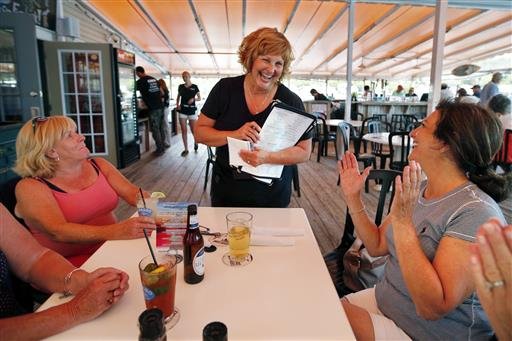 Ann LePage chats with diners after taking their order at McSeagull's restaurant, Thursday, June 23, 2016, in Boothbay Harbor. 