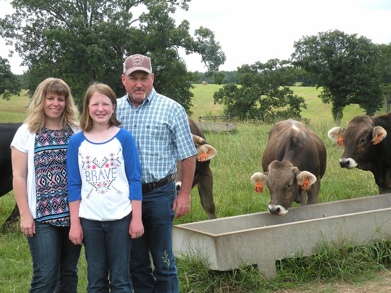 Chris Smith, right, and his wife, Nesha, and their 10-year-old daughter Jalyn was recently named the 2016 East Central District Farm Family of the year. The family raises cattle and hay and operates a construction company. The Smiths will now compete against seven other district winners for the state title, which will be announced December 8.