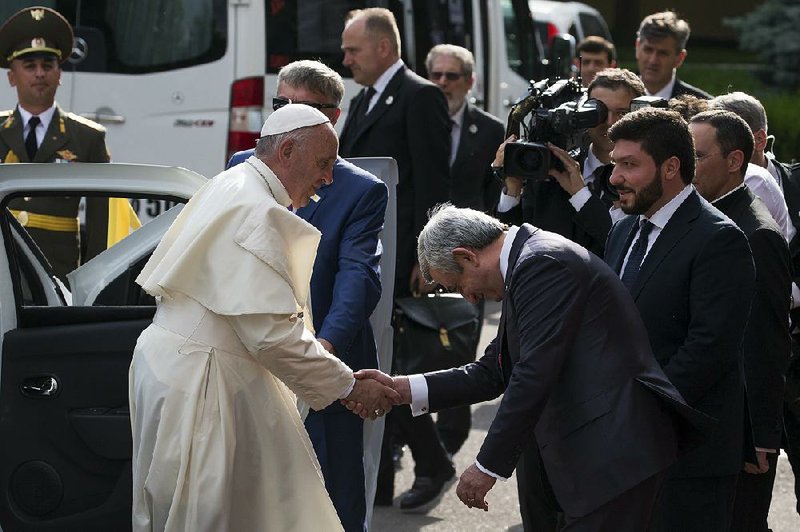 Armenian President Serzh Sargsyan greets Pope Francis as the pontiff arrives at the presidential palace Friday in Yerevan. 
