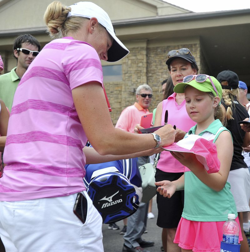 Grace Denegri, 10, from Memphis, gets an autograph from golfer Stacy Lewis Friday during the LPGA Wal-Mart NW Arkansas Championship at Pinnacle Country Club in Rogers. 