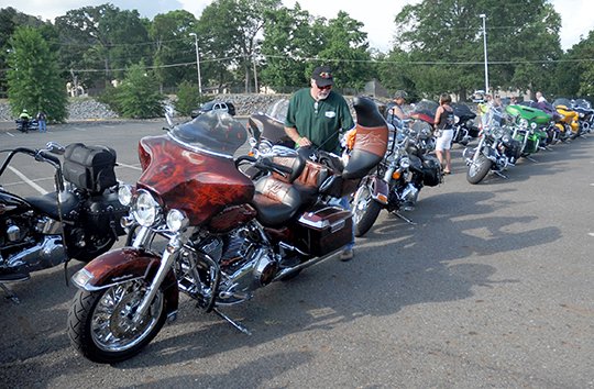 The Sentinel-Record/Mara Kuhn PARADE READY: Jesse Harris, with the Atlanta H.O.G. Chapter, readies his 2009 Ultra Harley-Davidson Friday for this year's parade through downtown Hot Springs.