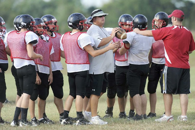 Former Pea Ridge Coach Tony Travis (center) takes over at Rogers Heritage, which went 0-10 a year ago under former coach Perry Escalante. Travis led Pea Ridge to the Class 4A semifinals a year ago.