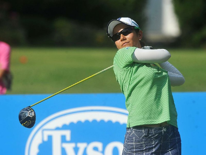 LPGA golfer Ai Miyazato watches her drive on the ninth hole Saturday in Rogers. Miyazato, the 2012 winner, shot a second-round 71 to finish eight strokes off the lead at 6-under-par 136.