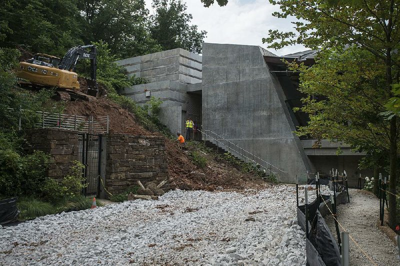A construction crew works on excavation Friday for the new north entrance to Crystal Bridges Museum of American Art in Bentonville. The project is set for completion in the spring. 