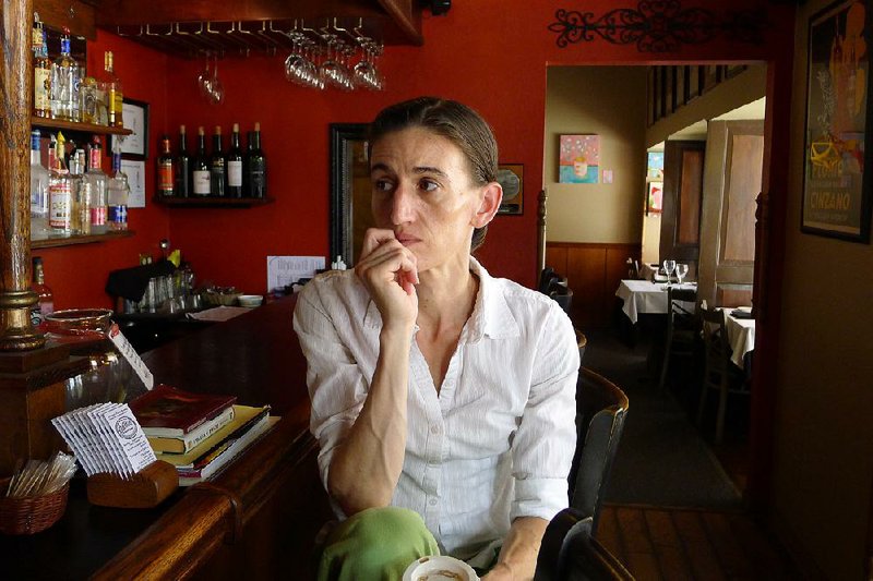 Bobbi Bins, an employee of DeVito’s Restaurant, listens to a co-worker as they talk about rental properties in downtown Eureka Springs. Bins said she has had trouble finding an apartment in the city. 