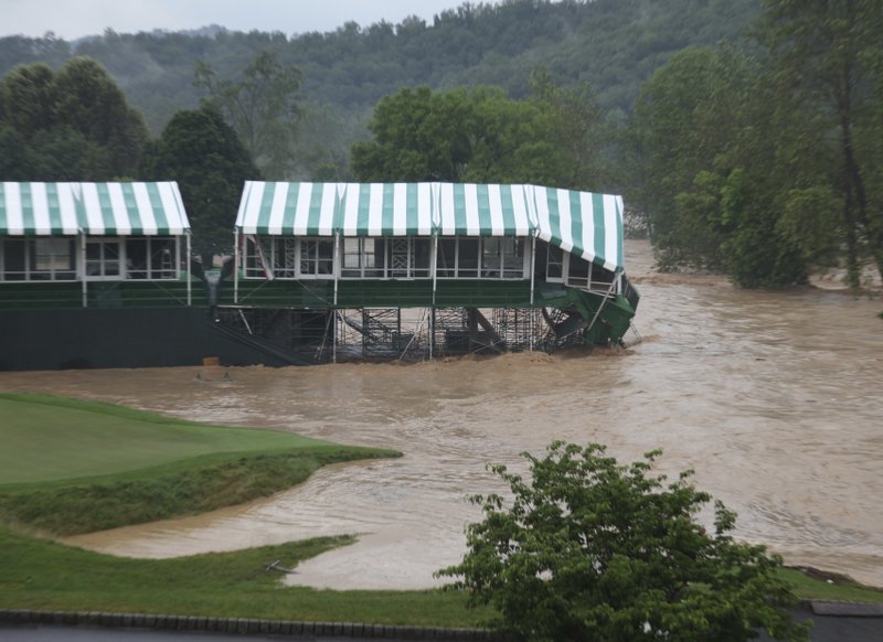 This Thursday June 23, 2016 image provided by the Greenbrier shows flooding on the 18th green of the Old White Course at the Greenbrier in White Sulphur Springs, W. Va. Severe flooding hit the area that is scheduled to host a PGA tour event in two weeks. 