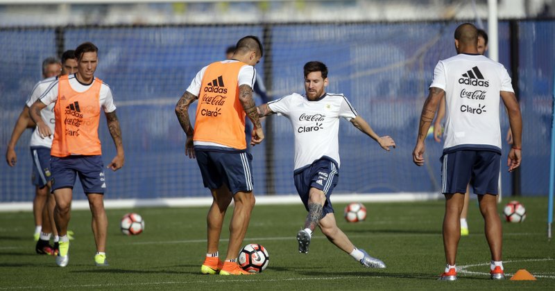Argentina's Lionel Messi, center, works against Victor Cuesta during a training session ahead of the team's Copa America soccer final against Chile, Friday, June 24, 2016, in East Rutherford, N.J. Argentina and Chile are scheduled to play for the championship Sunday in East Rutherford, N.J.