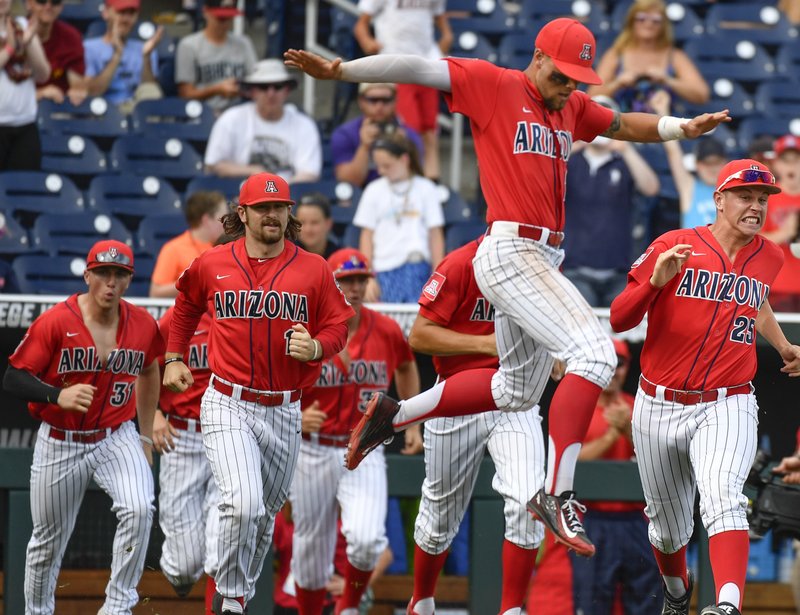 Arizona's JJ Matijevic, center, jumps for joy in front of his teammates as they celebrate their 5-1 win over Oklahoma State, following an NCAA men's College World Series baseball game in Omaha, Neb., Saturday, June 25, 2016. 