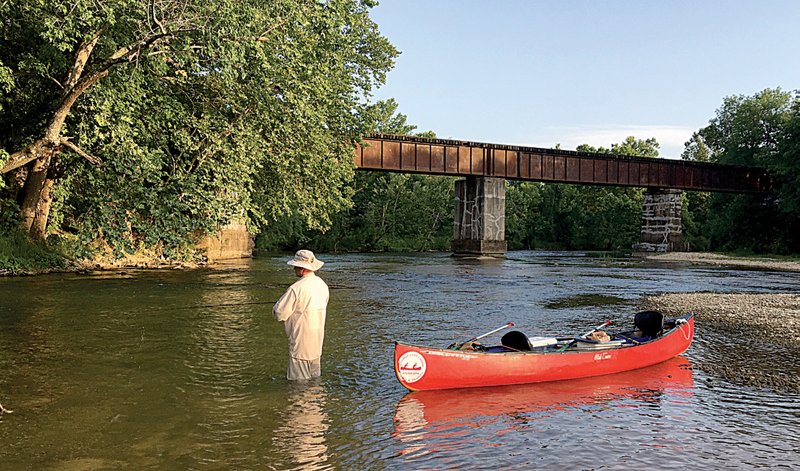 Rusty Pruitt of Bryant tries to catch a smallmouth bass Thursday at the Snow trestle on Crooked Creek. While low water conditions turned much of the float trip into back-breaking work, plenty of smallmouth bass were caught.