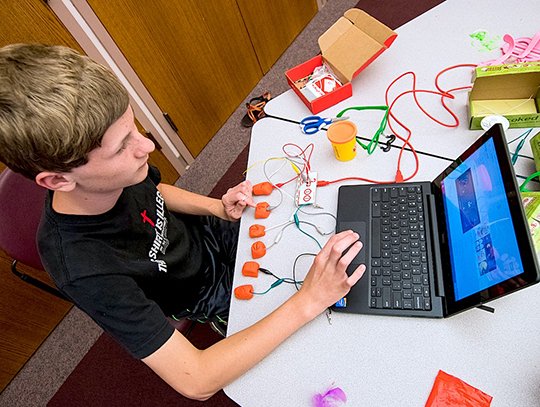 Logan Roseth, of Bismarck, developed his own set of controllers to play Pac-Man on a laptop computer June 8-9 during a coding and robotics camp at Henderson State University in Arkadelphia. Henderson alum Michelle Johnson, director of the gifted and talented program at Fountain Lake, and Matthew Sutherlin, chair of curriculum and instruction at Henderson, led the two-day workshop. The camp was presented by Henderson's TRIO Talent Search program in conjunction with the Henderson STEM Center. Students worked with invention kits, coding software and robots to write their own problem-solving programs.