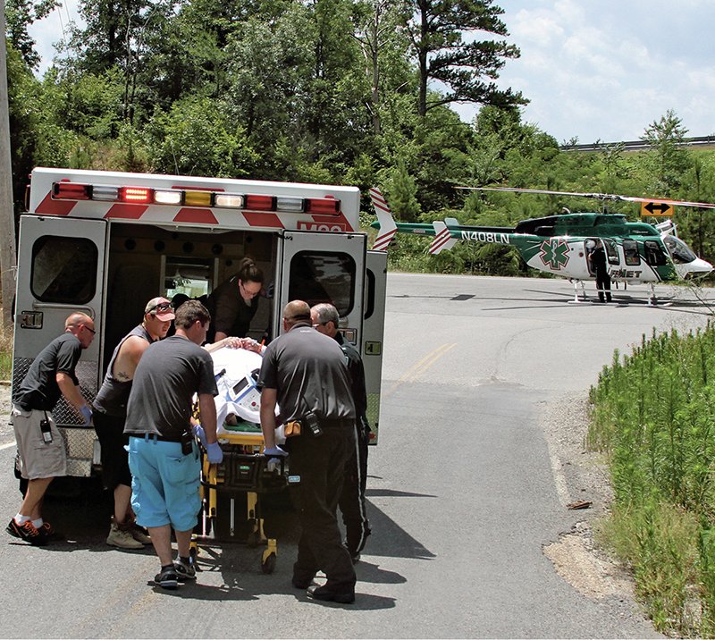 The Sentinel Record/Max Bryan Emergency personnel prepare to airlift a stabbing victim Saturday at the intersection of Cedar Creek Road and East Grand Avenue. The victim, who was not identified, was allegedly stabbed at 1342 Cedar Creek Road. LifeNet Air, LifeNet, Garland County Sheriff's Department and Morning Star Volunteer Fire Department responded to the scene.