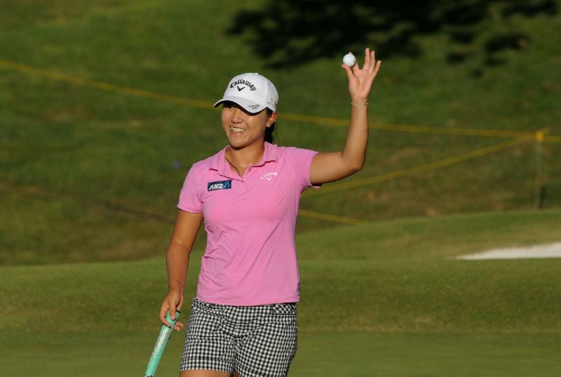 Lydia Ko, of New Zealand, acknowledges the crowd after winning the Wal-Mart LPGA NW Arkansas Championship on Sunday at Pinnacle Country Club in Rogers. Ko, 19, fi red a 3-under 68 in the fi nal round on Sunday to beat Morgan Pressel and Candie Kung by three shots to win for the third time this year and the 13th time on the tour. Ko entered the final round tied with Pressel.