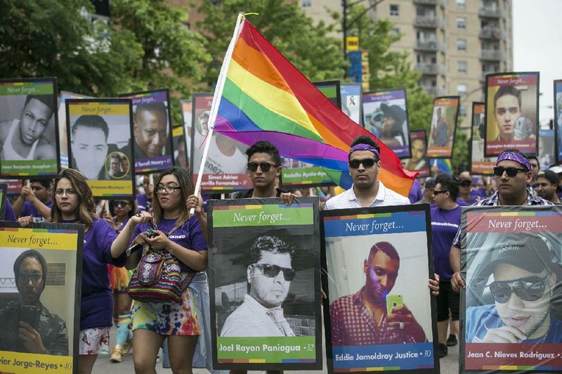 Participants in the 47th annual Chicago Pride Parade on Sunday carry pictures of the victims killed in the Pulse nightclub shooting.