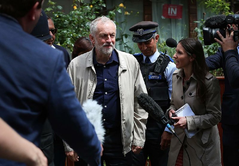 Labor Party leader Jeremy Corbyn faces members of the media as he leaves his house Sunday in London.