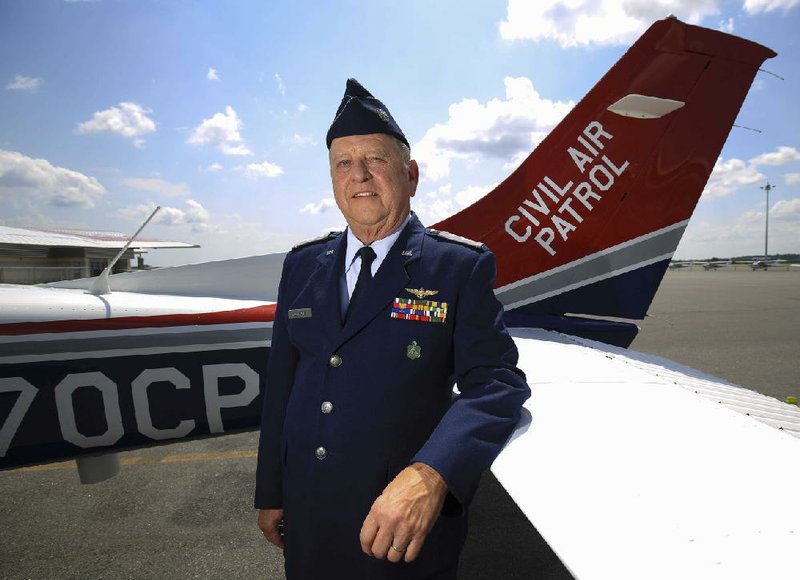 Pilot Joel Buckner, standing Friday beside one of the Civil Air Patrol’s planes, received the Federal Aviation Administration’s Wright Brothers master pilot award for his 50 years of flying.