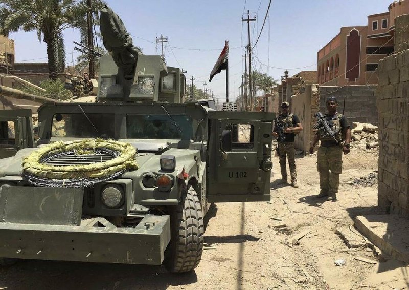 Iraqi security forces enter the al-Julan neighborhood of Fallujah on Sunday after defeating Islamic State militants. An Iraqi commander said Sunday that Fallujah has been recaptured. 