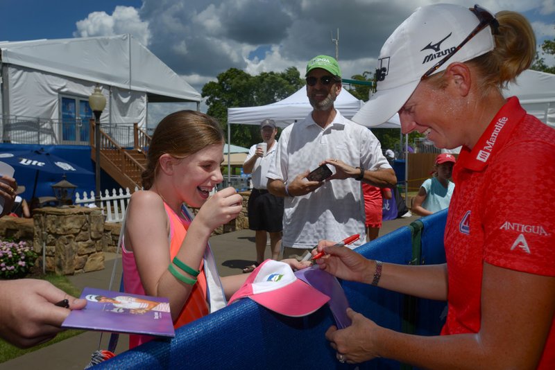 Haylee Lantz, 10, of Bella Vista reacts Sunday as Stacy Lewis signs a hat and ball for her on autograph alley during the final day of the LPGA Wal-Mart NW Arkansas Championship at Pinnacle Country Club in Rogers.