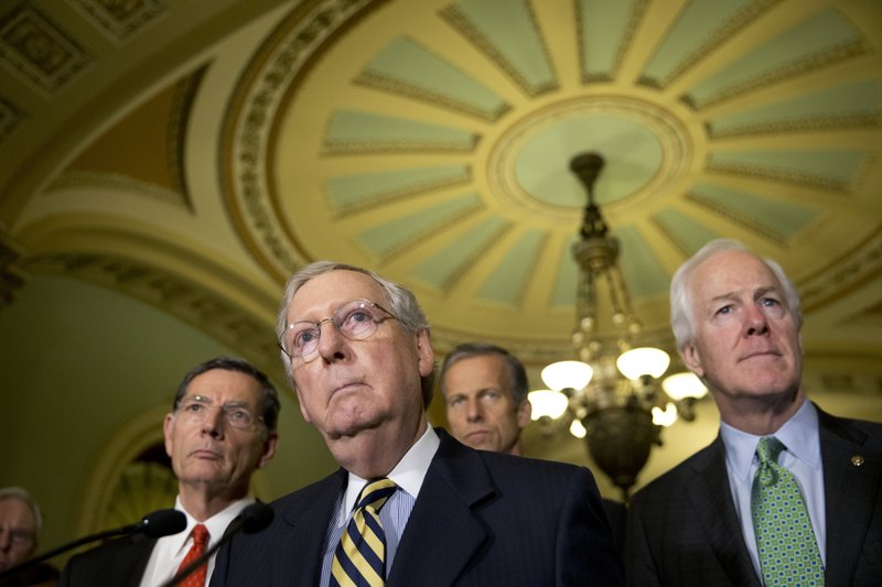 Majority Leader Mitch McConnell of Ky., second from left, accompanied by, from left, Sen. John Barrasso, R-Wyo., Sen. John Thune, R-S.D., and Senate Majority Whip John Cornyn of Texas, listen to a question during a news conference on Capitol Hill in Washington, Tuesday, June 21, 2016, following their policy luncheon. 