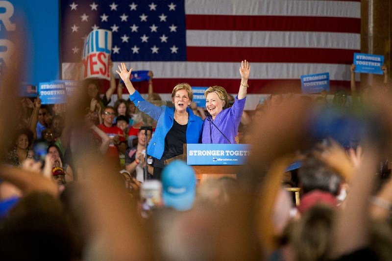 Democratic presidential candidate Hillary Clinton is introduced Monday by Sen. Elizabeth Warren, D-Mass., at a rally at the Cincinnati Museum Center at Union Terminal in Cincinnati.