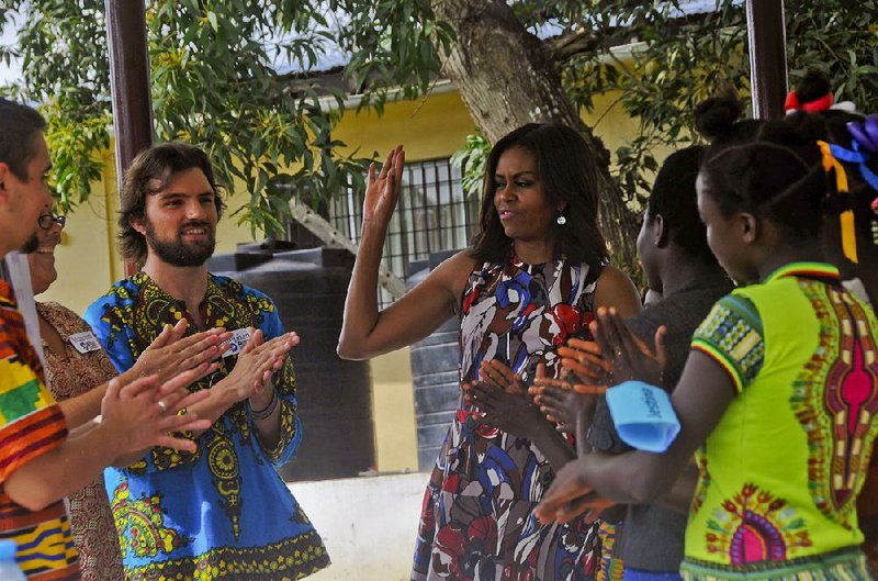 U.S. first lady Michelle Obama interacts with Peace Corps members at a project in Kakata, Liberia, on Monday.
