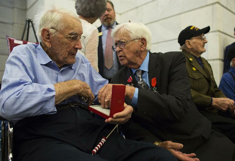 Kenneth Smith (left) and James Siler talk after they received the French Legion of Honor medal during a ceremony at the state Capitol on Monday. Both men served in France in WWII and were honored with 10 other veterans.