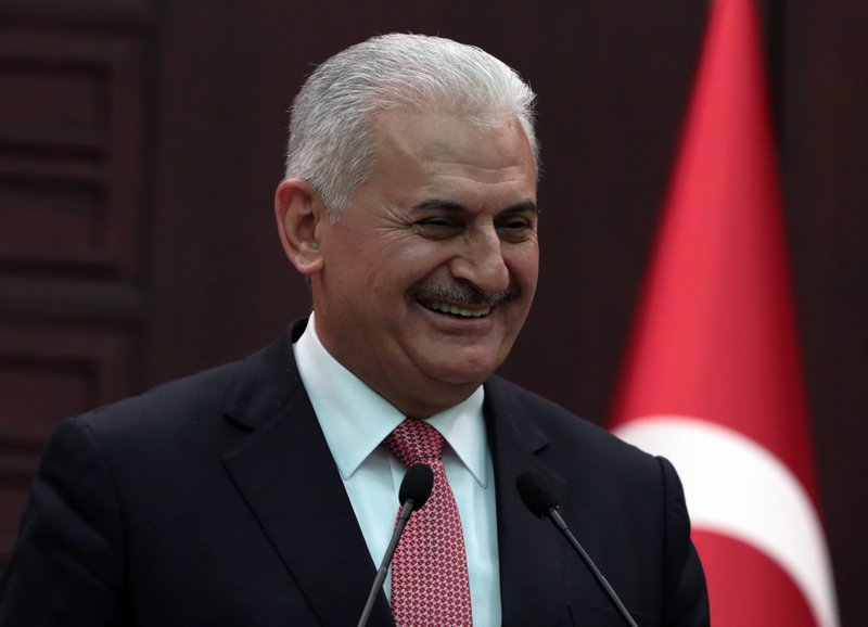 Turkey's Prime Minister Binali Yildirim smiles as he announces the details of an agreement reached with Israel, in Ankara, Turkey, Monday, June 27, 2016. 