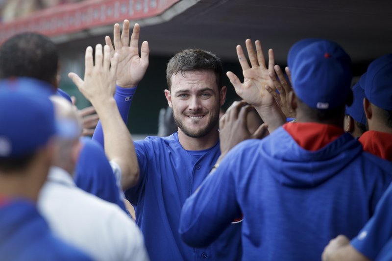 Chicago Cubs' Kris Bryant celebrates in the dugout after scoring on an RBI sacrifice fly by Miguel Montero off Cincinnati Reds starting pitcher Dan Straily in the first inning of a baseball game, Monday, June 27, 2016, in Cincinnati. 