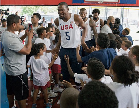 The Associated Press AMERICAN ICON: Kevin Durant greets kids who participated in a basketball clinic as he arrives for a news conference Monday in New York. Durant, facing free agency starting July 1, leads the United States' 12-man Olympic roster into the August Rio Games, announced Monday.
