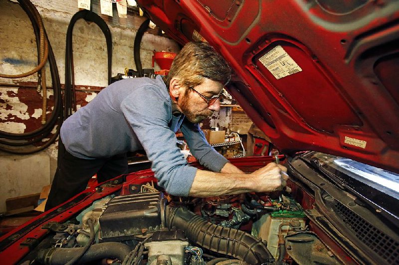 Auto mechanic Joe Valenti changes the battery in a Honda Acura at his garage in Dormont, Pa., in March. The Commerce Department said Tuesday that the U.S. economy grew at a 1.1 percent annual rate in the first quarter. 