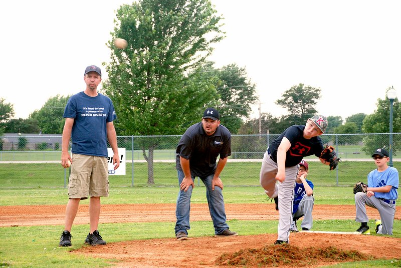 Jeff Della Rosa/Special to Siloam Proud At left, Mike Williamson, president of Siloam Springs Youth Baseball, watches as a young pitcher throws a ball during All Star tryouts at James Butts Baseball Complex.