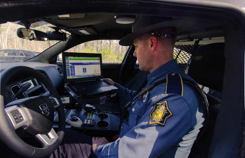 Damon Dobson, Arkansas State Police trooper, enters data into an electronic ticketing system used by the organization. Plans call for the system to be offered to local law enforcement agencies next year.

