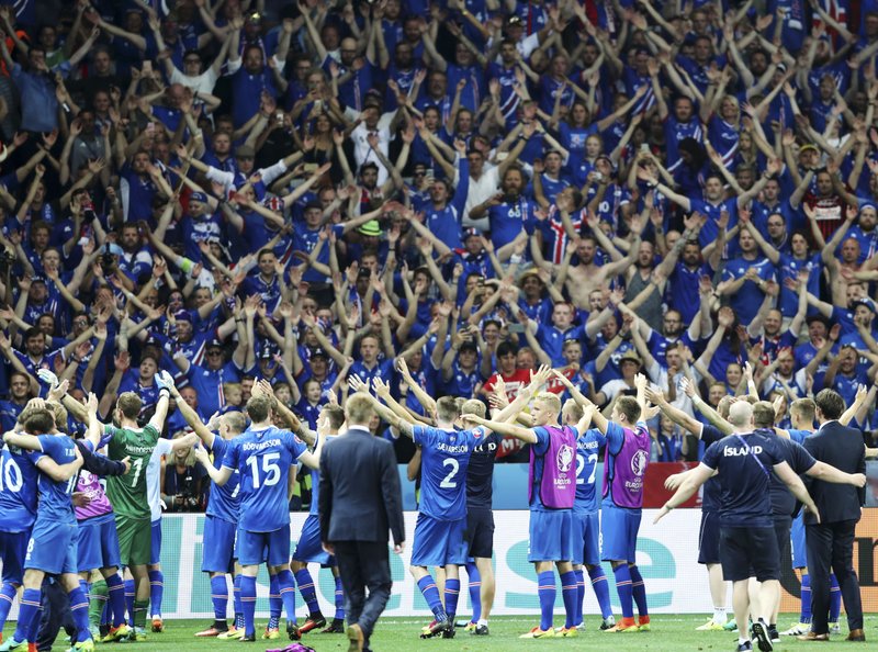 Iceland players celebrate with the supporters at the end of the Euro 2016 round of 16 soccer match between England and Iceland, at the Allianz Riviera stadium in Nice, France, Monday, June 27, 2016. 