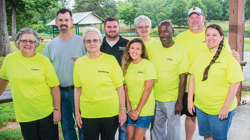 Linda Benton, from left, Ronnie Benton, Barbara Stevens, Craig Robinson, Jessica Robinson, Twyla Land, David Moody, Darren Gordon and Stacy Gordon stand under the pavilion at Friendly Acres Park in Judsonia. As part of the Judsonia Activities Committee, they are getting ready for Summer Blast, the annual community Fourth of July celebration at the park, set to take place Saturday.