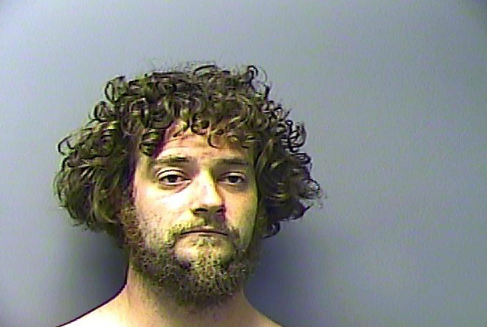 David Joshua Burkhart was arrested Tuesday night after police said they found him naked and charged him with public intoxication and attempted burglary. 