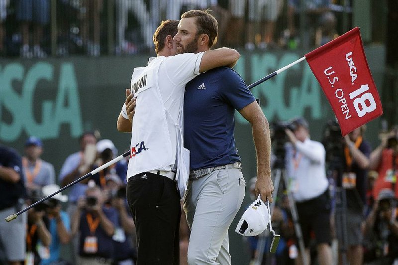Dustin Johnson (right) hugs his caddie and younger brother, Austin, after winning the U.S. Open at Oakmont, Pa., on June 19. Johnson returns to play today at the WGC Bridgestone Invitational in Akron, Ohio.