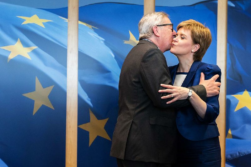European Commission President Jean-Claude Juncker greets Scotland First Minister Nicola Sturgeon as she arrives Wednesday at EU headquarters in Brussels. Sturgeon discussed Scotland’s desire to remain in the EU but said challenges lie ahead in finding a path to do so.