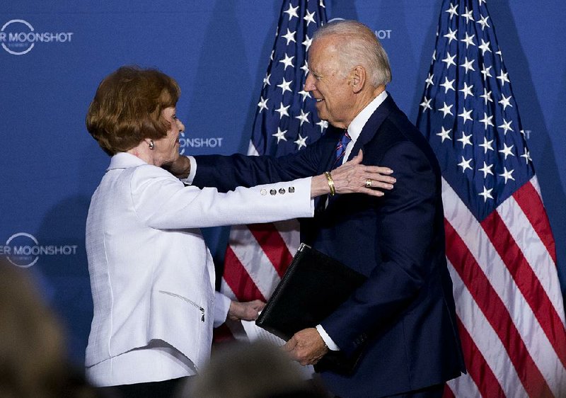 Vice President Joe Biden embraces comedian Carol Burnett after she introduced him Wednesday at the Cancer Moonshot Summit at Howard University in Washington. 