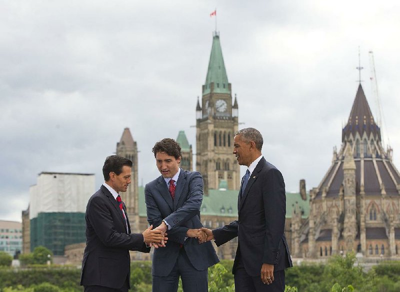 Mexican President Enrique Pena Nieto (from left), Canadian Prime Minister Justin Trudeau and President Barack Obama trade handshakes Wednesday at the National Gallery of Canada in Ottawa.