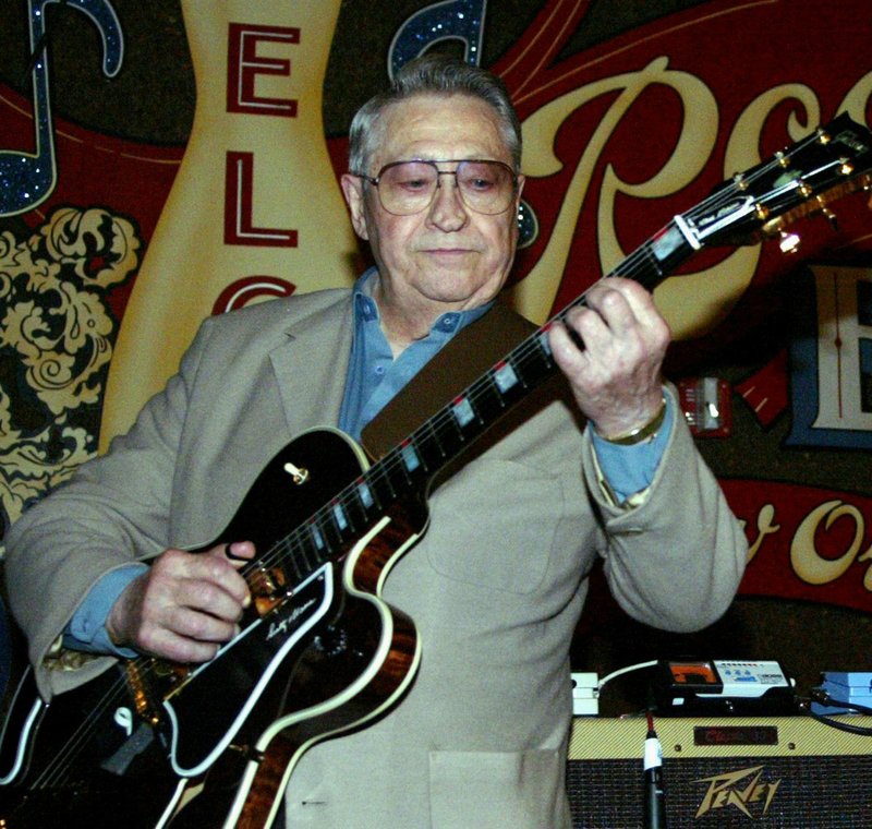 This April 30, 2003, file photo shows Scotty Moore, a former guitarist for Elvis Presley, playing music at the 2nd annual Ponderosa Stomp in New Orleans. 