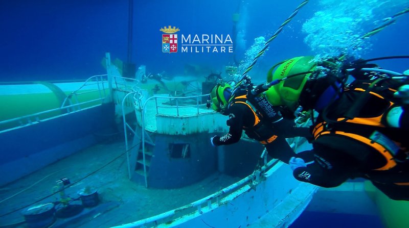 The Italian Navy works Tuesday to recover the migrant ship that sank off Sicily last year.