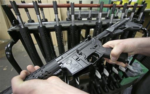 In this April 10, 2013, file photo, a man holds a newly-assembled AR-15 rifle in New Britain, Conn.