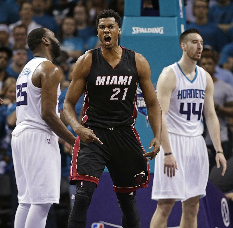 Hassan Whiteside (center) made less than $1 million while playing with the Miami Heat last season. With the NBA’s salary cap expected to leap from $70 million to near $95 million, Whiteside figures to draw around $20 million per season in free agency.