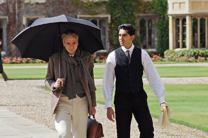 G.H. Hardy (Jeremy Irons) and Srinivasa Ramanujan (Dev Patel) work on sophisticated mathematical postulates in The Man Who Knew Infinity.