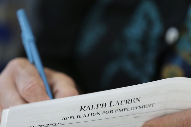 In this Tuesday, Oct. 6, 2015, file photo, a job seeker fills out a job application during a job fair at Dolphin Mall in Miami. On Thursday, June 30, 2016, the Labor Department reports on the number of people who applied for unemployment benefits the week before. 