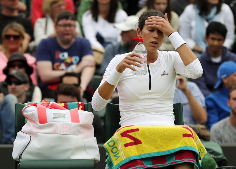 Garbine Muguruza of Spain has a drink during a break in her women's singles match against Jana Cepelova of Slovakia on day four of the Wimbledon Tennis Championships in London, Thursday, June 30, 2016.